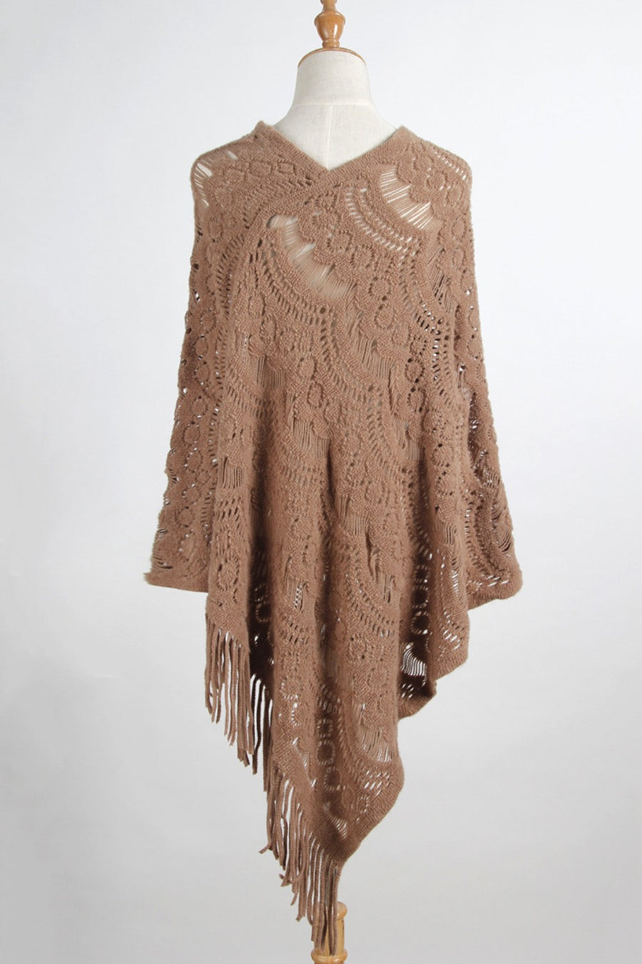 Camel crochet poncho with intricate lace pattern and fringe details