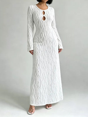 White long sleeve maxi dress with textured wavy pattern and keyhole cutout neckline.