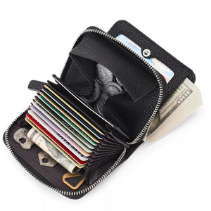 Black pebbled leather card wallet open with cards, coins, and cash.