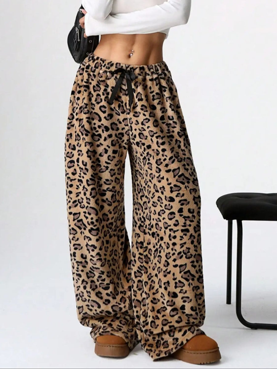 Leopard print lounge palazzo trousers with a black bow detail and wide leg.