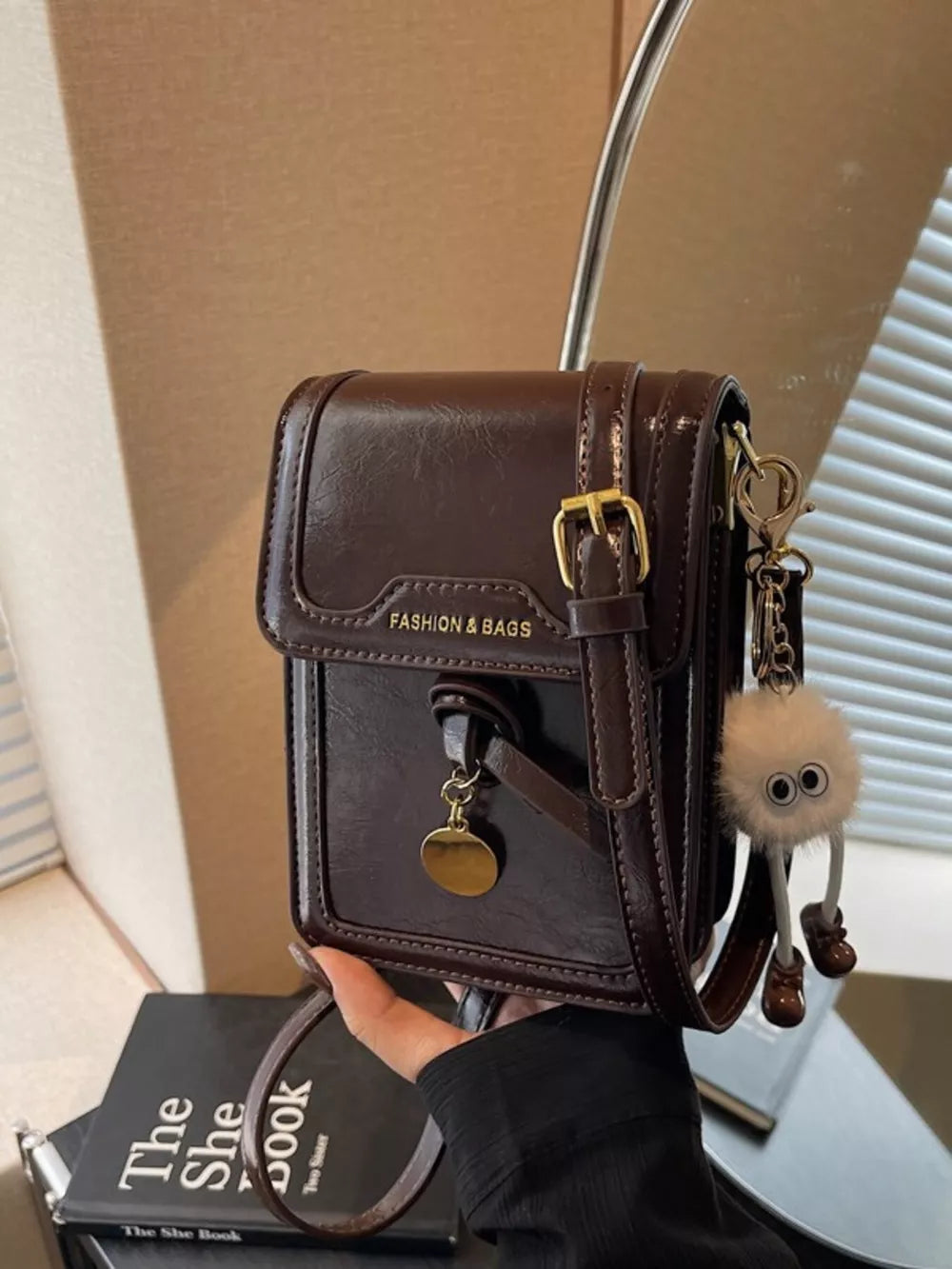 Caramel pu leather mini crossbody bag with gold buckle and fluffy charm