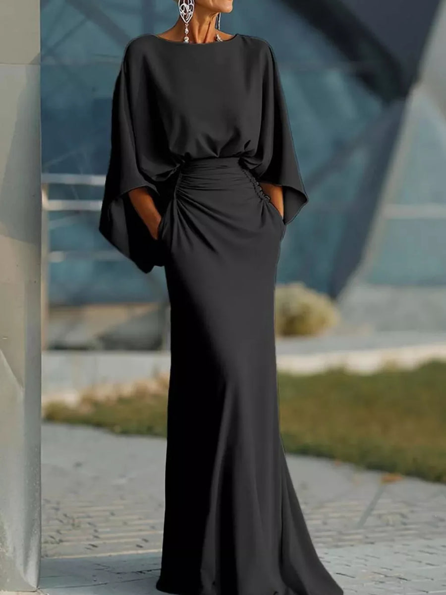 Black batwing sleeve maxi dress with ruched waist detail and pockets.