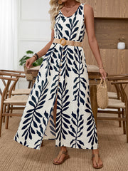 Belted maxi dress with tropical leaf print, scoop neck, and decorative buttons.