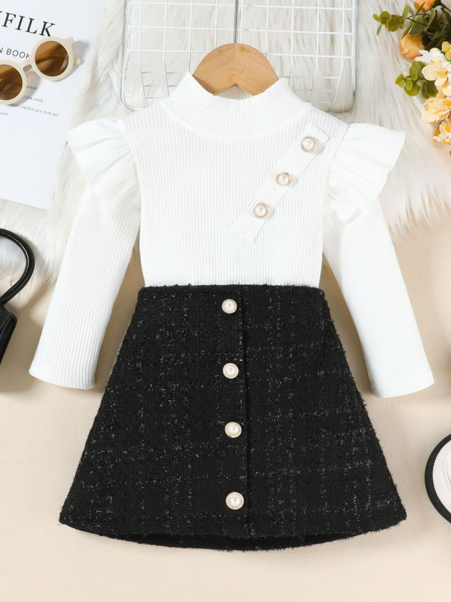 White ruffle sleeve top with pearl buttons and black tweed A-line skirt set.