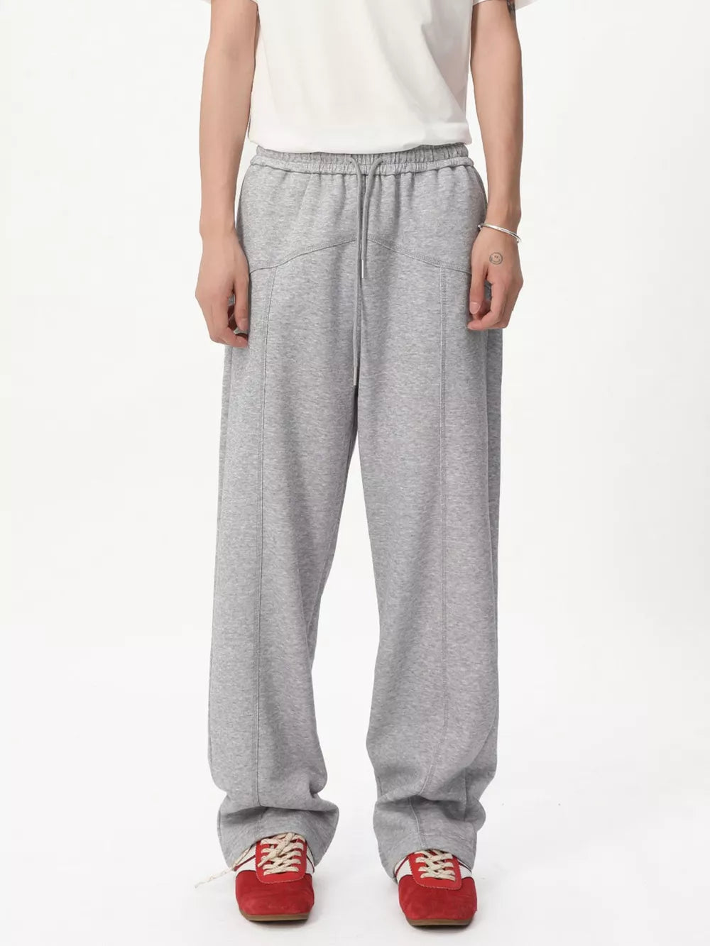 Gray cotton sweatpants with drawstring waist and wide legs.