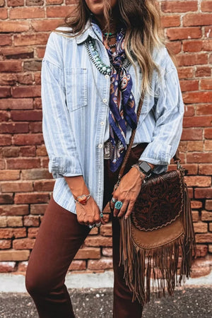 Relaxed light blue striped denim shacket with button-down front and chest pockets.