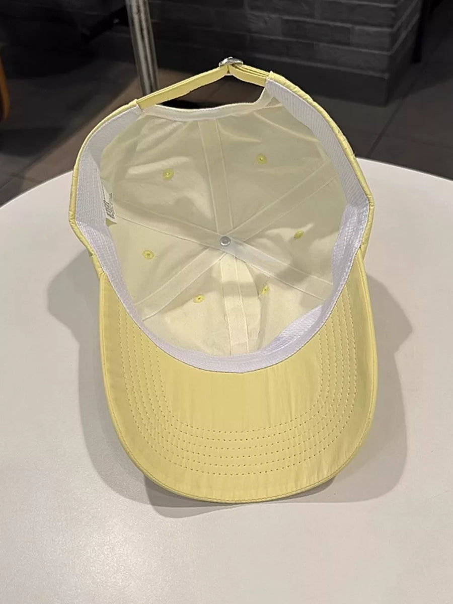 Yellow baseball cap with adjustable strap and white interior band