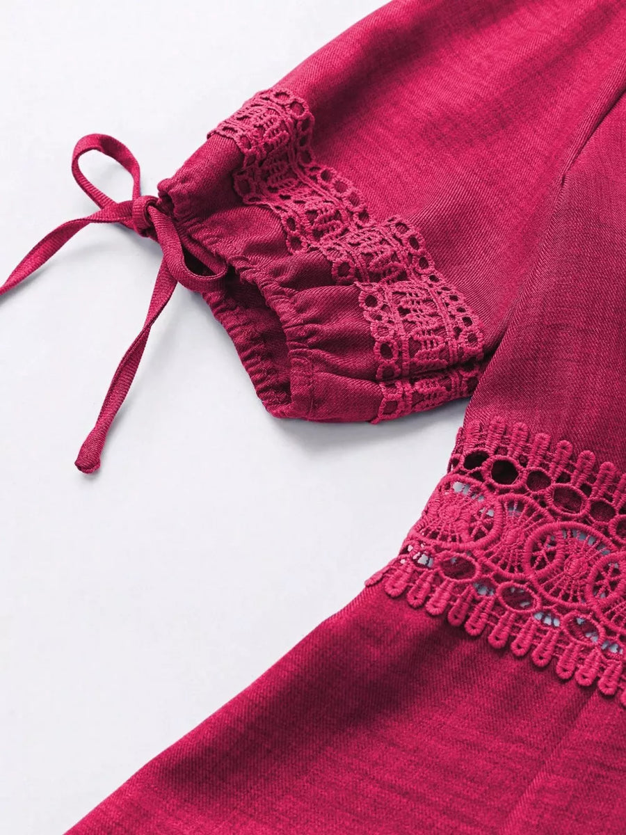 Rose red mini dress with lace trim on sleeves and hem, featuring tie details.