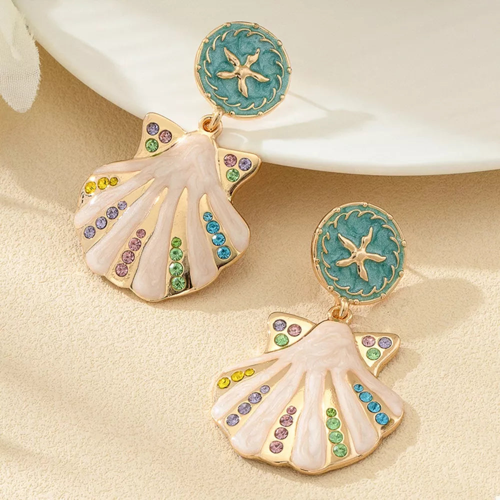 light pink earrings featuring dangle and motif