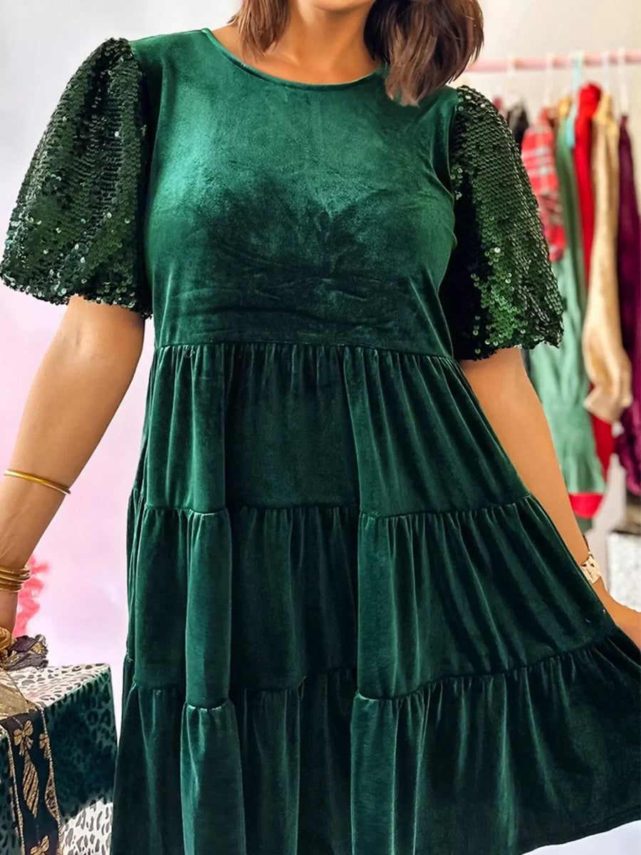 Dark green velvet tiered mini dress with sequin puff sleeves.