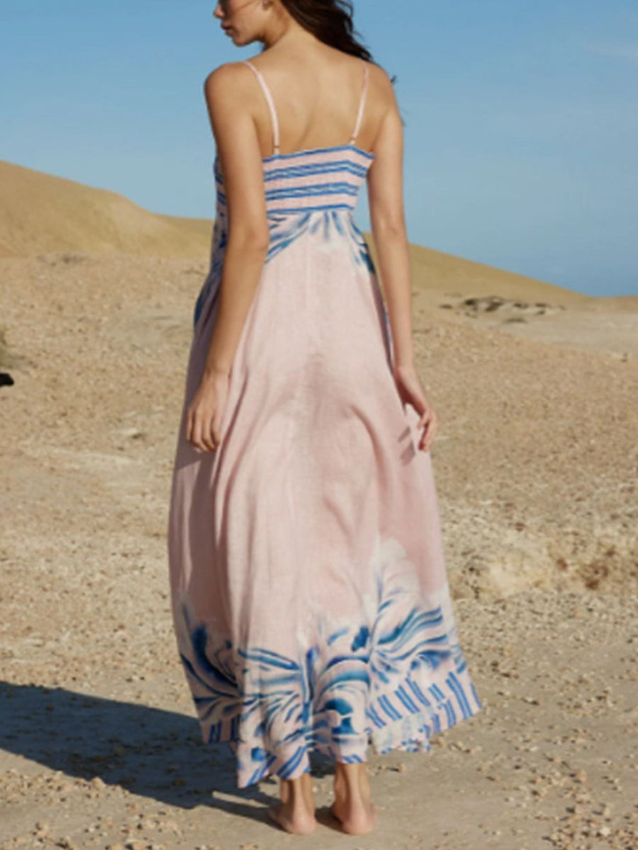 Pink spaghetti strap maxi dress with blue abstract print and bustier detail.