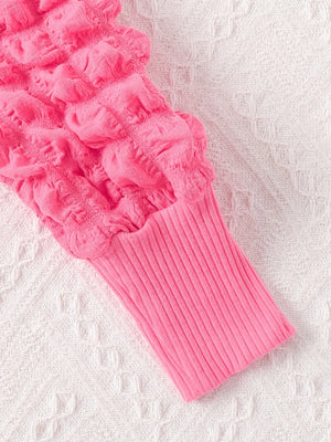 Pink baby dress with bubble texture and ribbed cuff