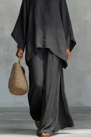 Flowing black polyester two-piece set with wide-leg pants and a loose top.