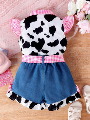 Baby girl cow print top with pink gingham trim and denim shorts.