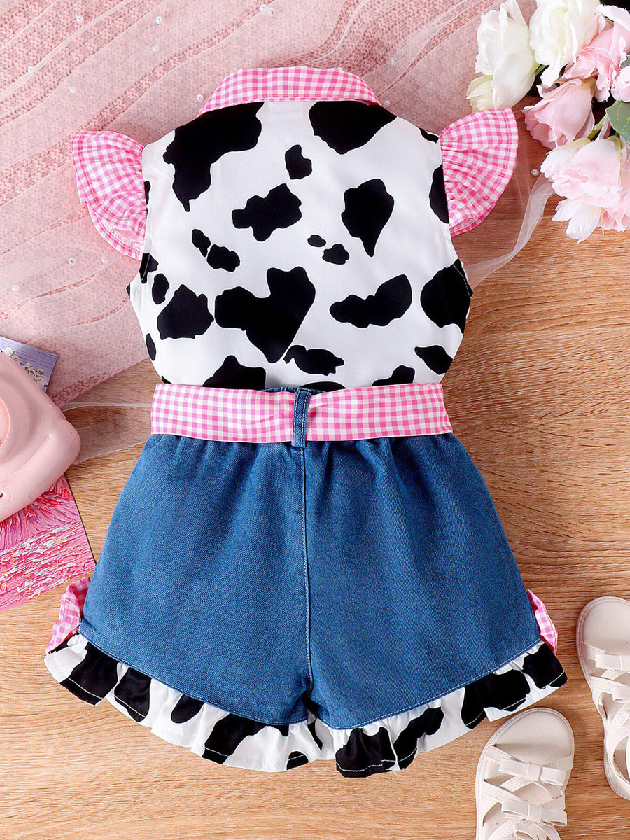 Baby girl cow print top with pink gingham trim and denim shorts.