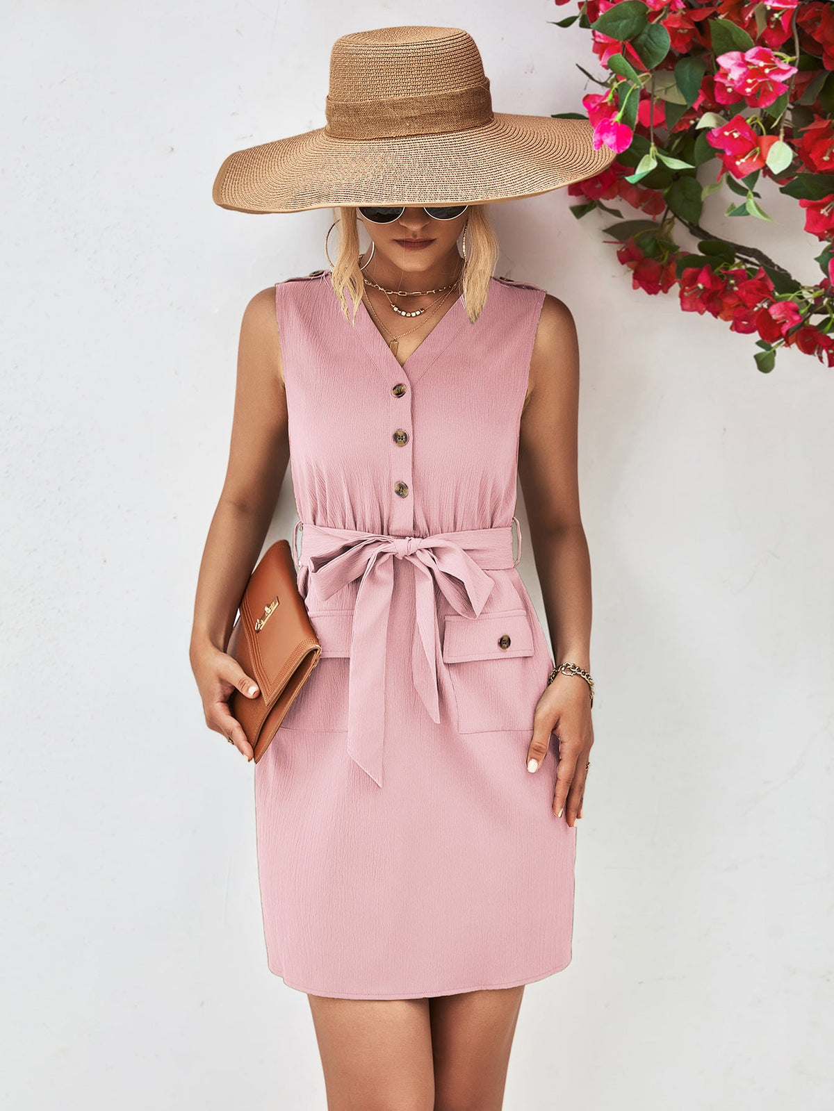 Blush pink button-down tie-waist sleeveless shirtdress with pockets and a belted waist.