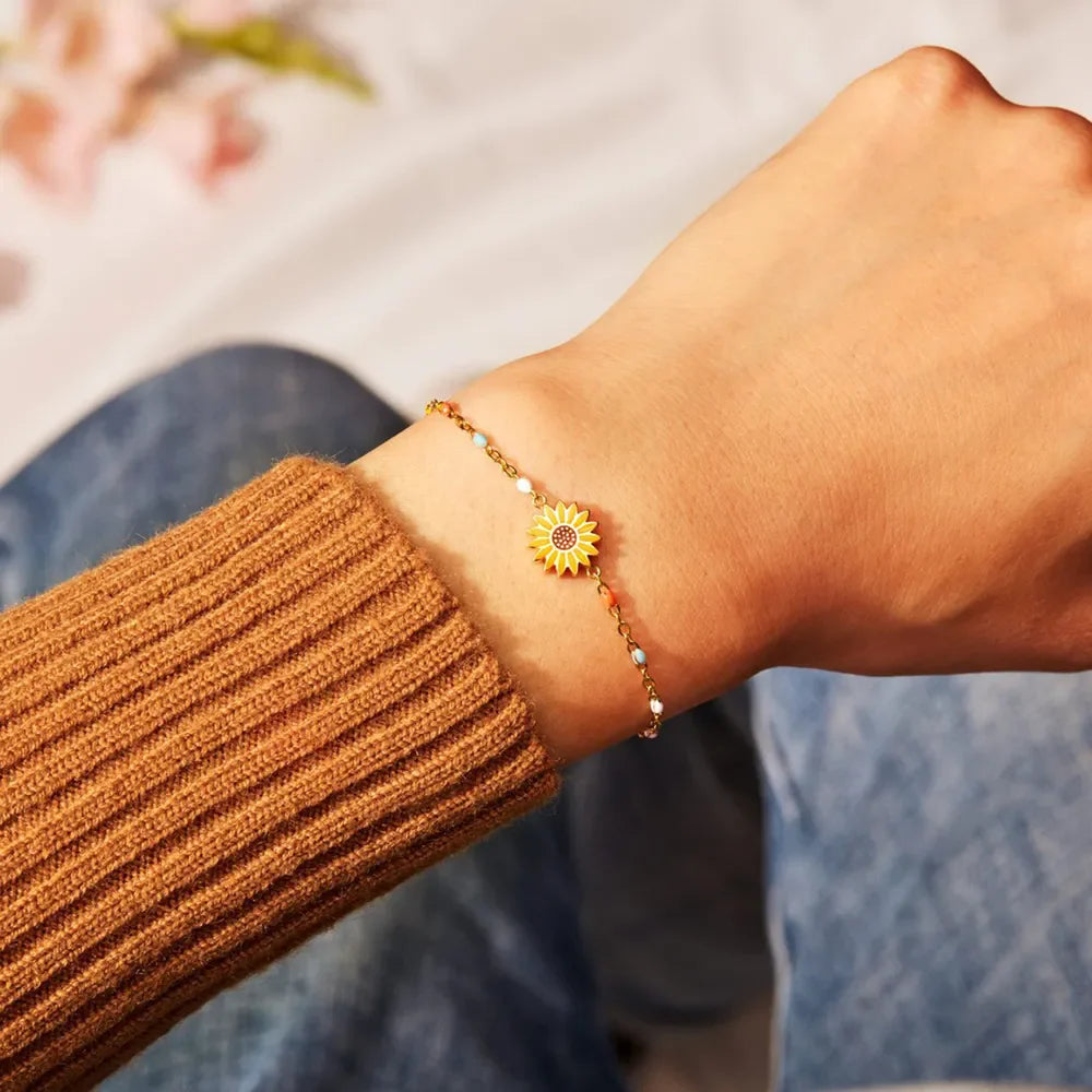 Gold beaded bracelet with a sunflower charm and colorful accent beads