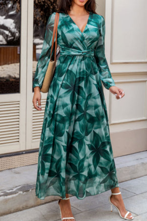 V-neck wrap maxi dress in green botanical print with long sleeves and tie waist.