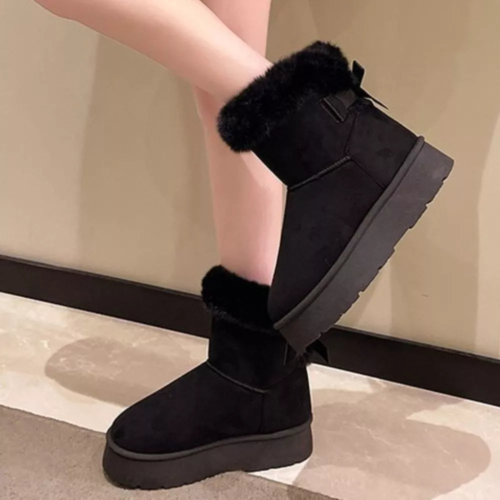 Black suede round-toe boots with fur trim and bow detail