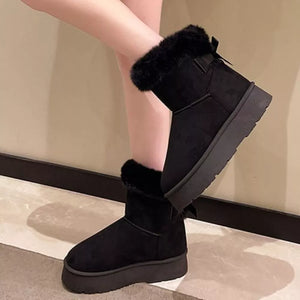 Black suede round-toe boots with fur trim and bow detail