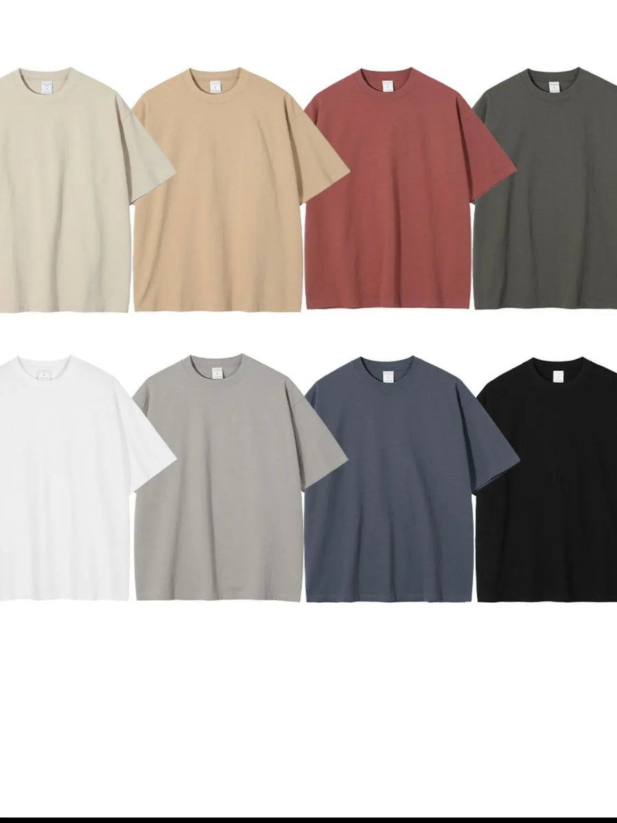 Oversized crewneck tees in Rust, Camel, Gray, Dusty Blue, Army Green, White, Beige, and Black.