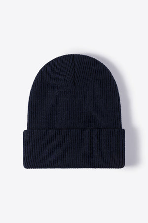 Navy ribbed knit beanie with a cuffed brim.