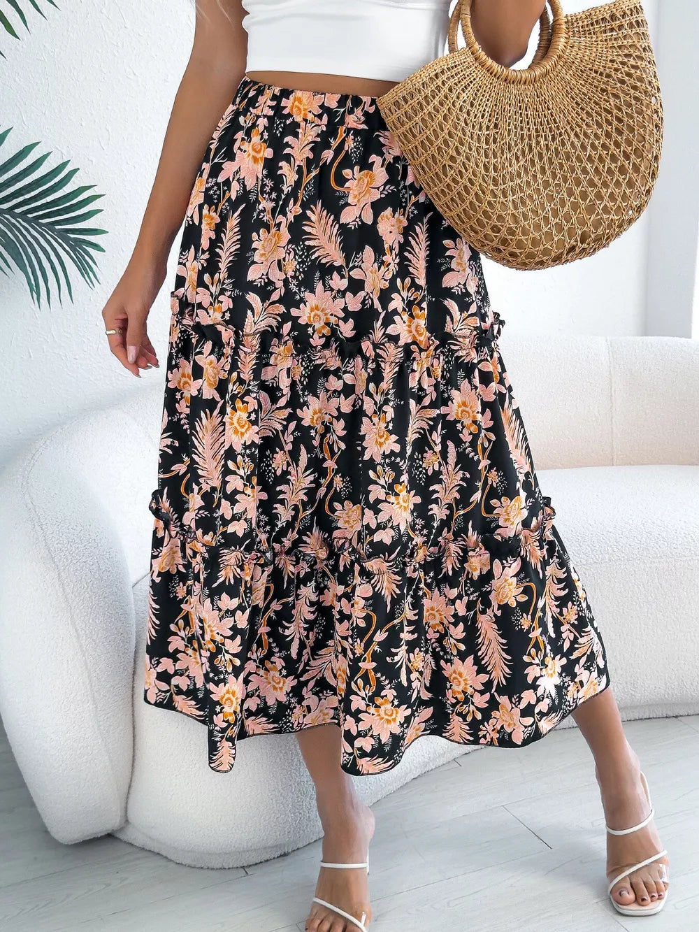 Black floral midi skirt with ruffle hem and tiered design.
