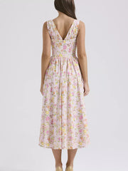 Floral print midi dress in pink with a V-neck and a-line skirt.
