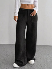 Black corduroy wide-leg trousers with front pockets and a relaxed fit.