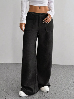 Black corduroy wide-leg trousers with front pockets and a relaxed fit.