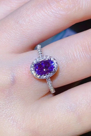 Silver ring with oval purple moissanite and diamond halo