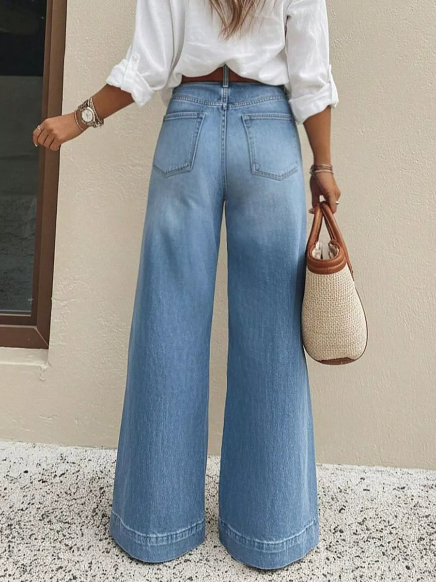 Light wash denim wide-leg jeans with pockets and a flared hem.