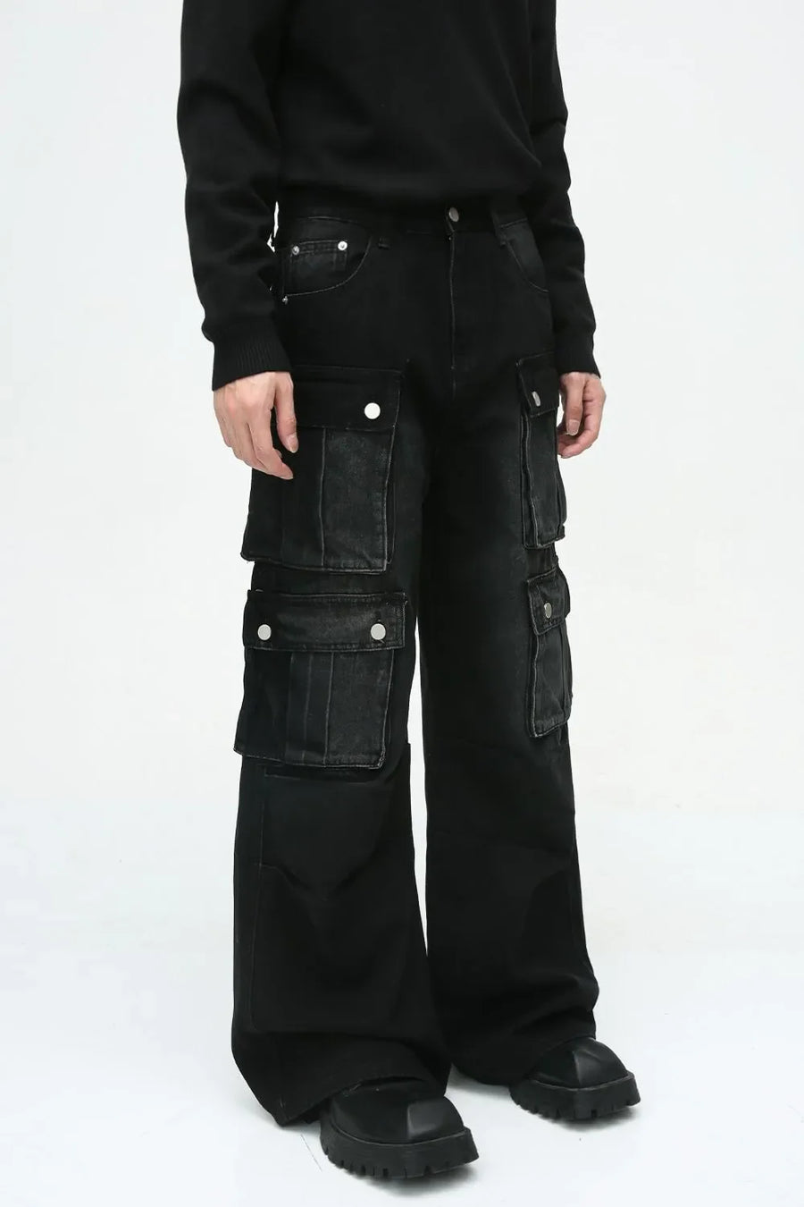 Dark denim wide-leg cargo pants with multiple utility pockets and silver button details.