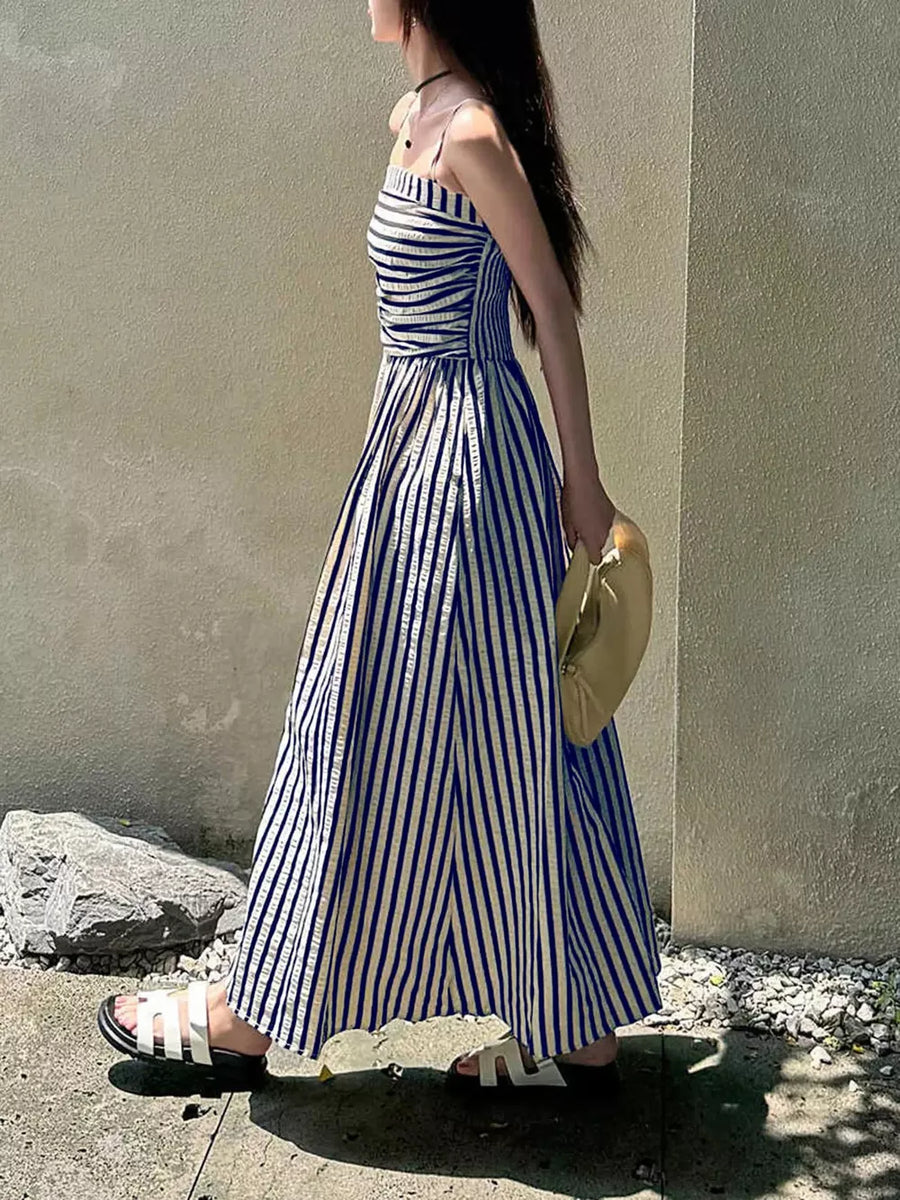 Navy blue and white striped maxi dress with spaghetti straps and a side slit.