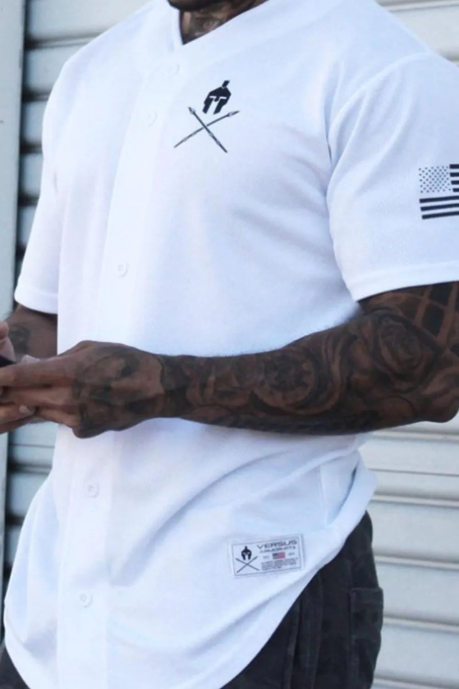 White baseball jersey with graphic detail on chest and sleeve, button front.