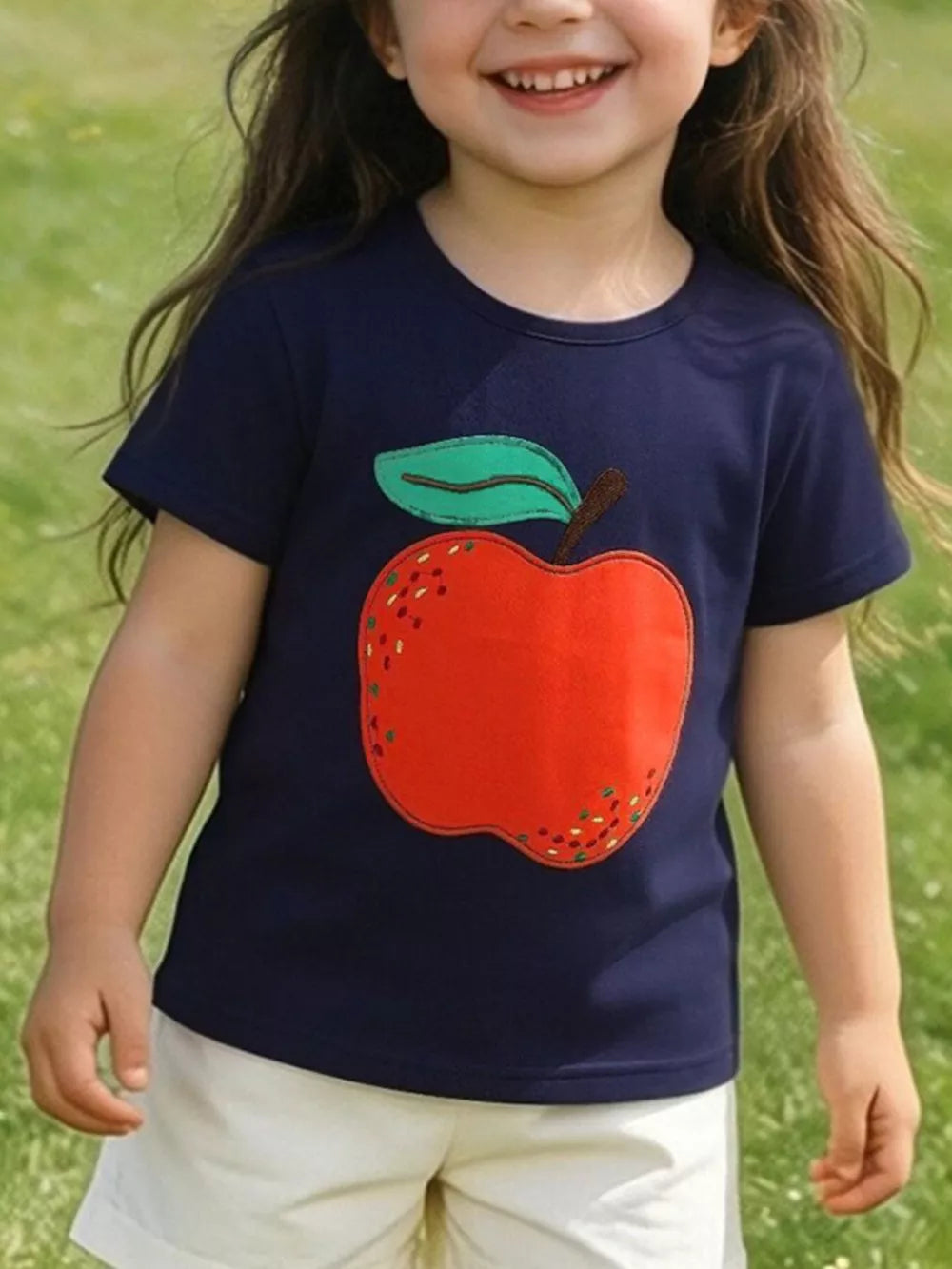 Navy cotton t-shirt with a cheerful red apple appliqué and green leaf detail.