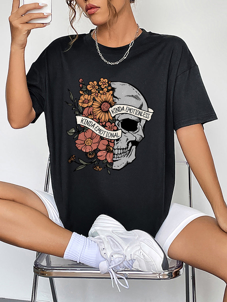 Black oversized tee with skull and floral graphic, featuring text "Kinda Emotional Kinda Emotionless".