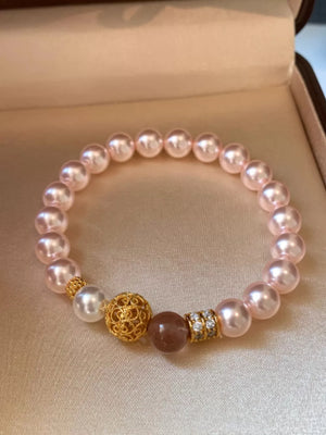 Blush pink pearl beaded bracelet with gold accents and crystal details