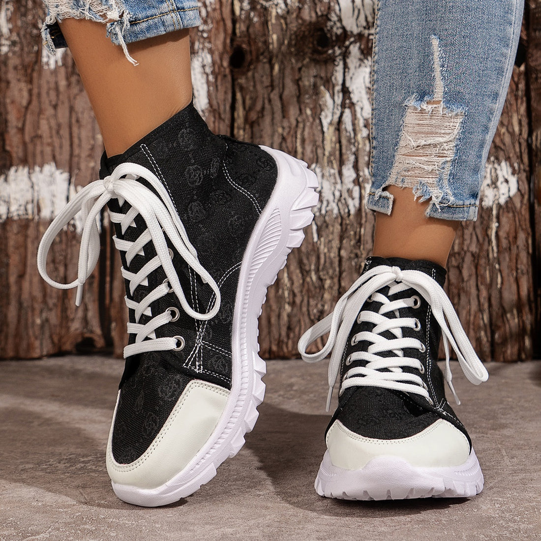 Black canvas high-top sneakers with white laces and chunky soles.