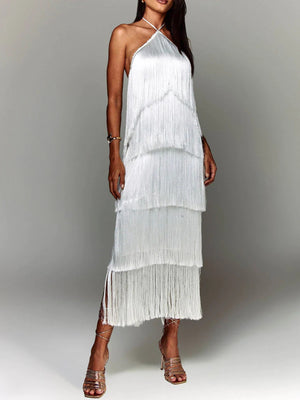 White halter neck maxi dress with tiered fringe detail and side slits.
