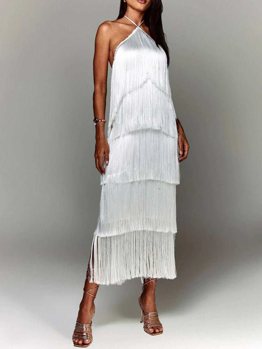 White halter neck maxi dress with tiered fringe detail and side slits.