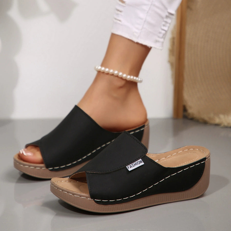 Black open-toe wedge sandals with contrast stitching and a "Fashion" label.