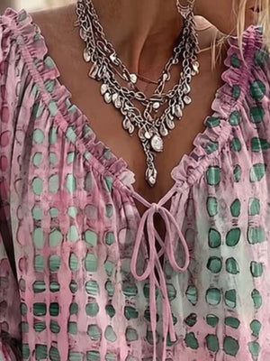 mint green blouse featuring tied and abstract-print