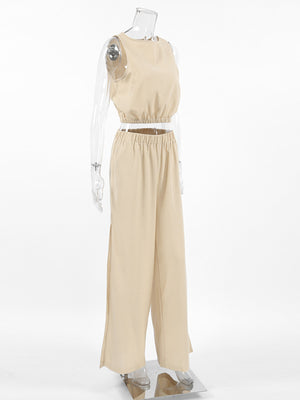 Tan sleeveless crew neck crop top and wide-leg pants set with elastic waistband and side slits.