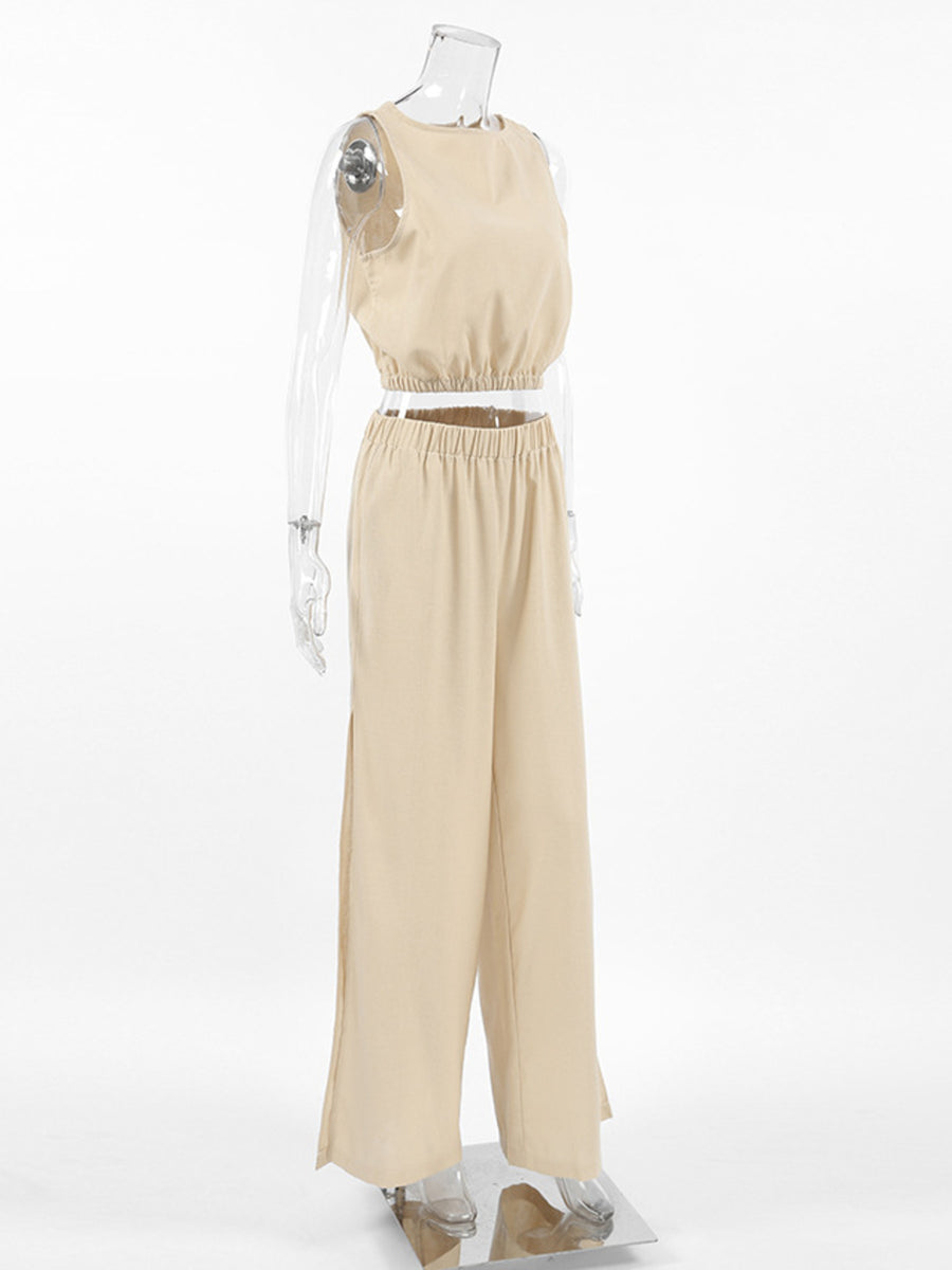 Tan sleeveless crew neck crop top and wide-leg pants set with elastic waistband and side slits.