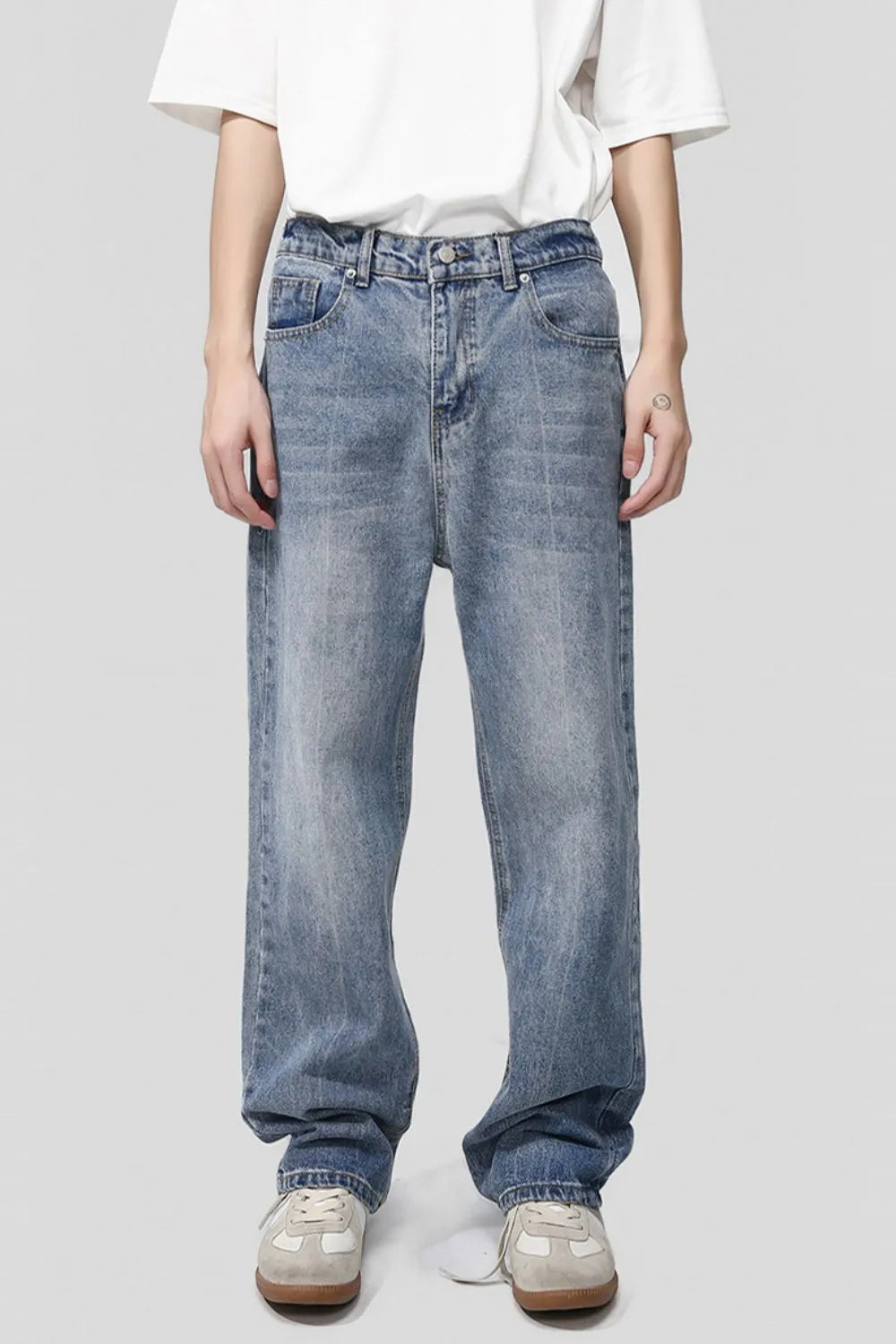 Pocketed denim jeans in medium wash, featuring a relaxed fit and classic five-pocket styling.
