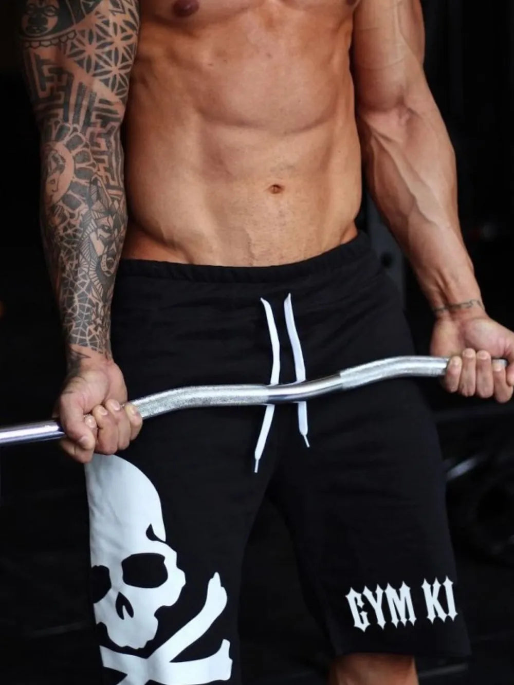 Black jogger shorts with white skull and crossbones graphic and Gym King logo.
