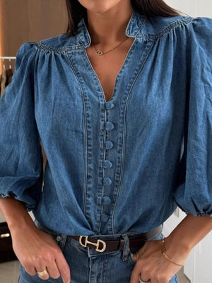 Denim button-down blouse with puff sleeves and a V-neckline.