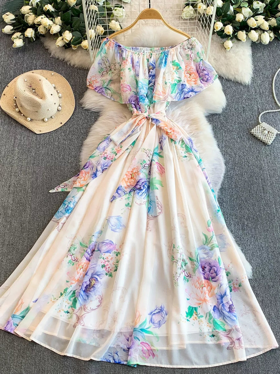 Botanical off-shoulder A-line dress in light pink with floral print, ruffled sleeves, and belted waist.