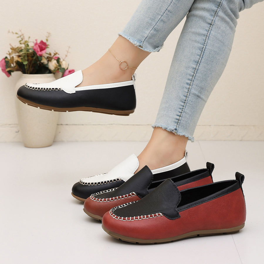 slip-ons in black featuring round toe and flat fit
